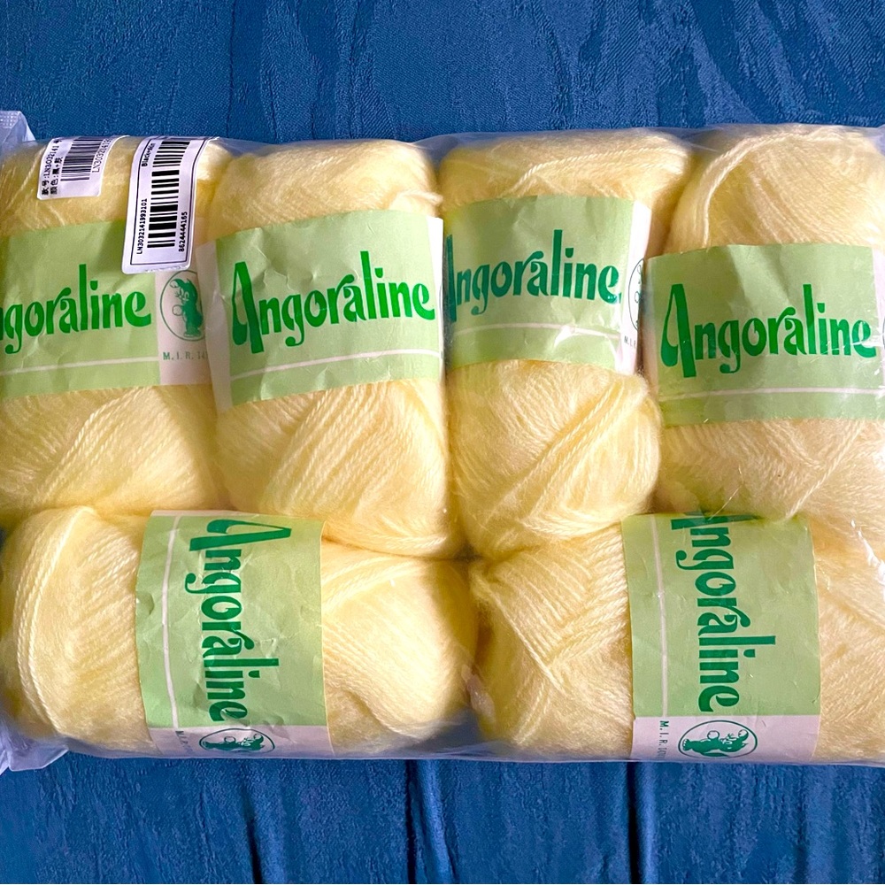 Six yellow skeins of yarn, new, 40 grams each.